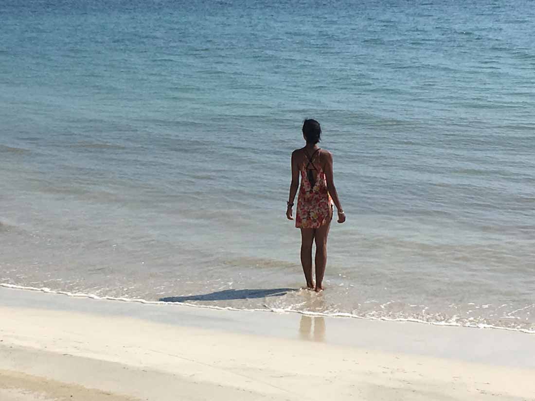 Image of me during my travels standing on a bright sunny beach staring out to sea, searching for the answers to the questions I was asking.