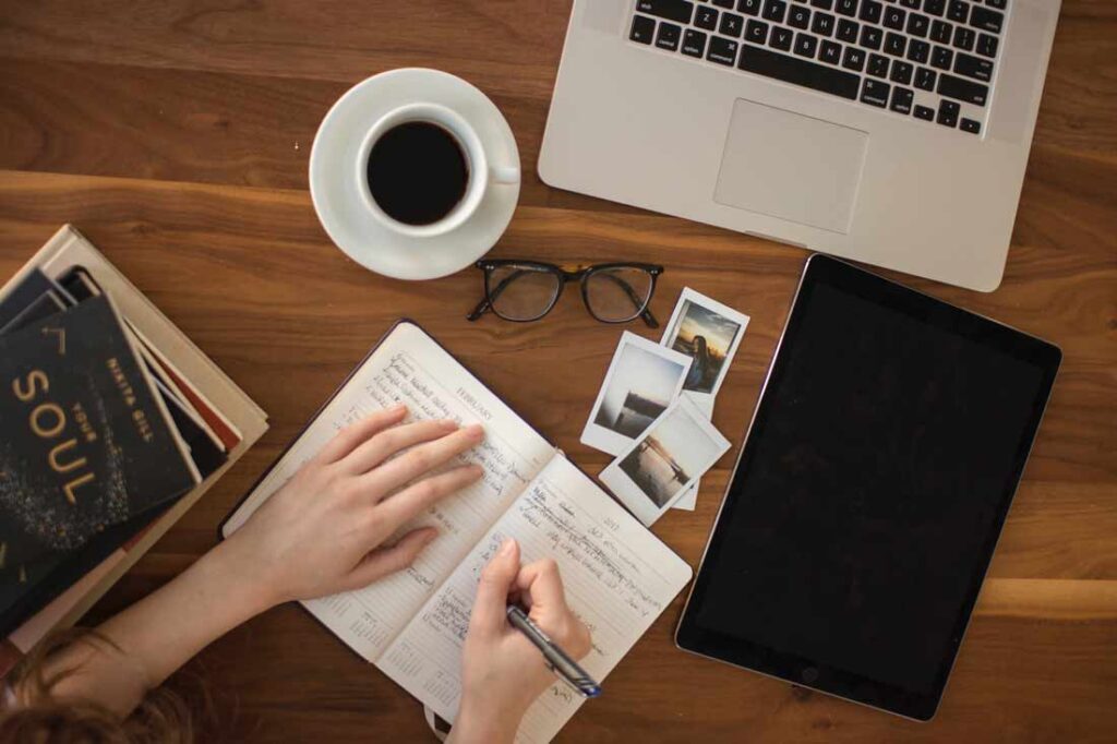 Journaling can help you process your emotions and work through your blockages whether they're related to past, current or future events. A continued practice will lead you to a better understanding of yourself and reconnecting with the most authentic version of you. Image of someone journalling.